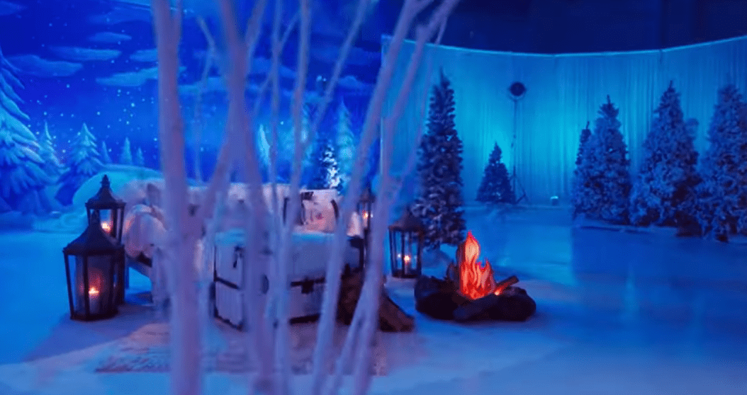 Winter-themed room with cozy fireplace scene.